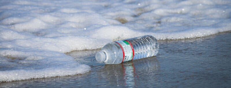discarded-bottle-on-the-beach