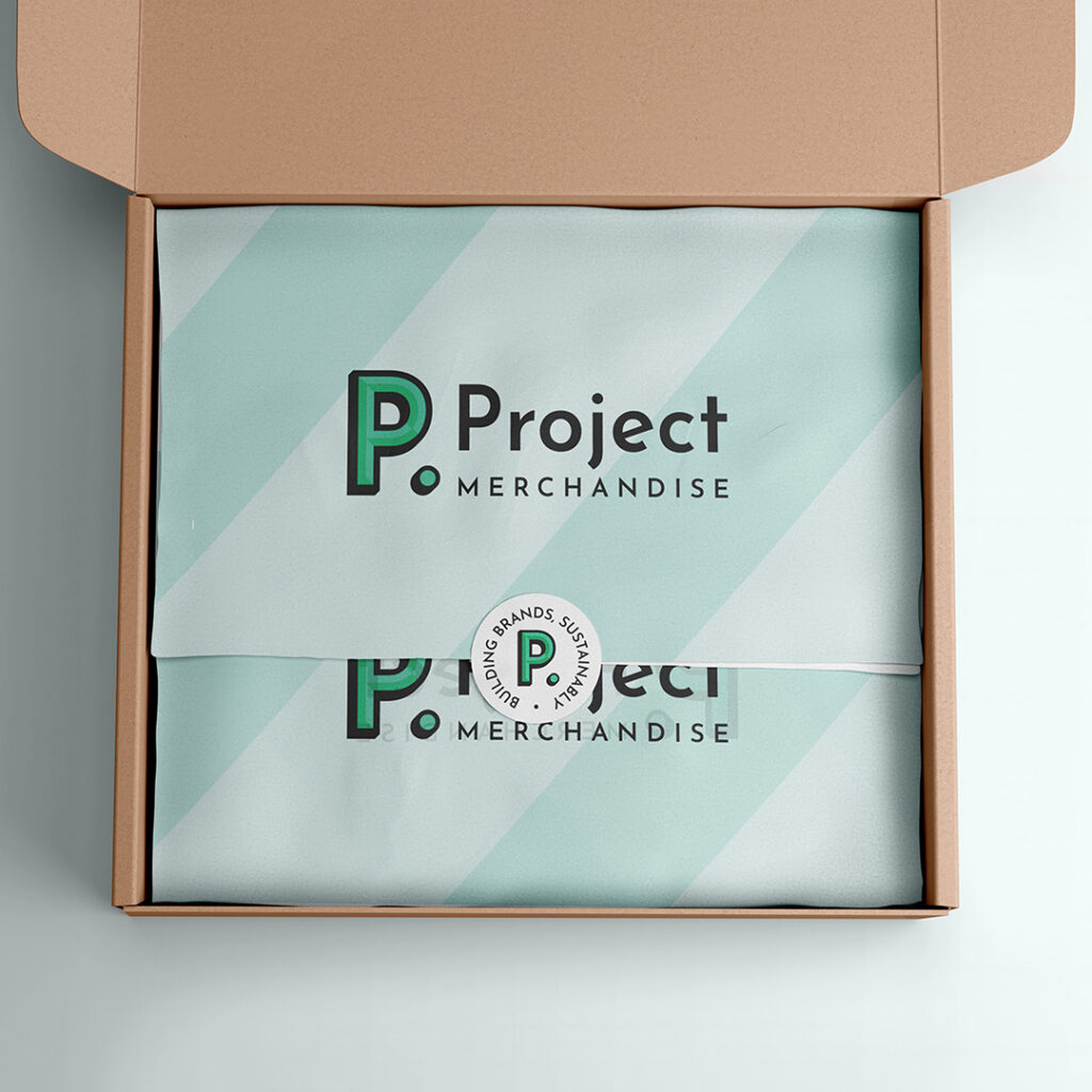 a-recycled-cardboard-box-with-branded-tissue-paper-and-project-merchandise-logo-sticker
